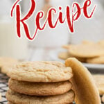 A stack of chewy soft sugar cookies on a cooling rack.