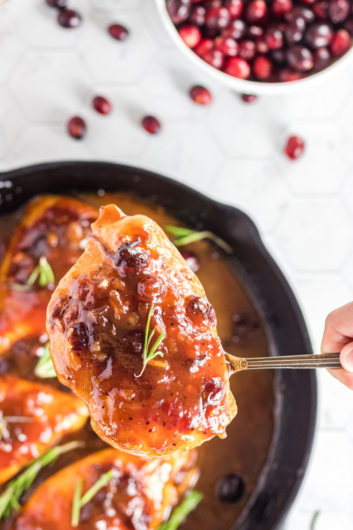 A chicken breast covered with sauce being served.