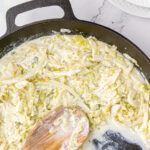 Skillet with cabbage in it with a text overlay for Pinterest.