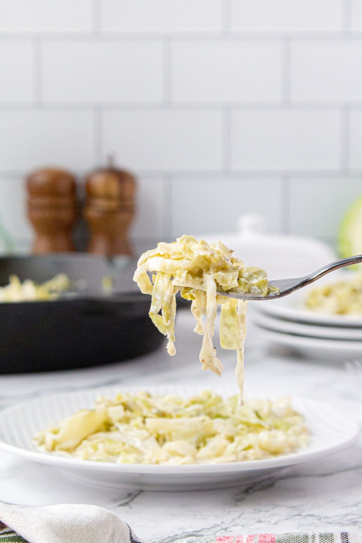 A forkful of cabbage being lifted from the plate.