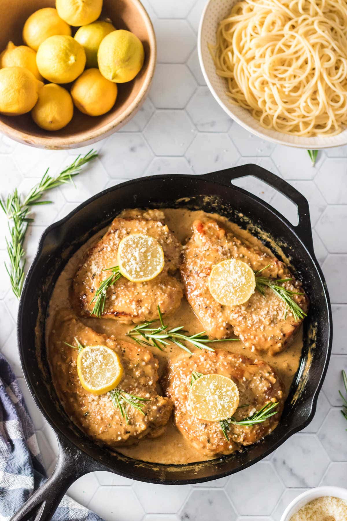 Overhead view of finished chicken in sauce in a skillet.