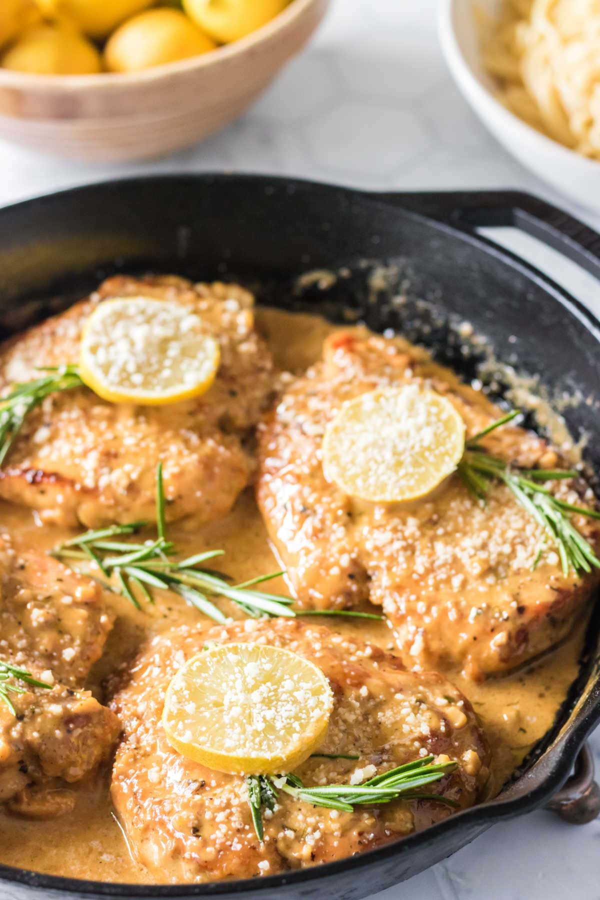 Closeup view of the lemon chicken in a skillet.