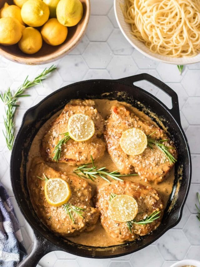 Overhead view of finished chicken in sauce in a skillet.