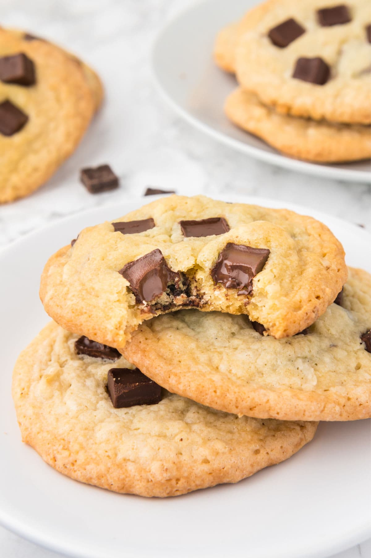 A cookie with a bite taken out of it showing the gooey chocolate chips.