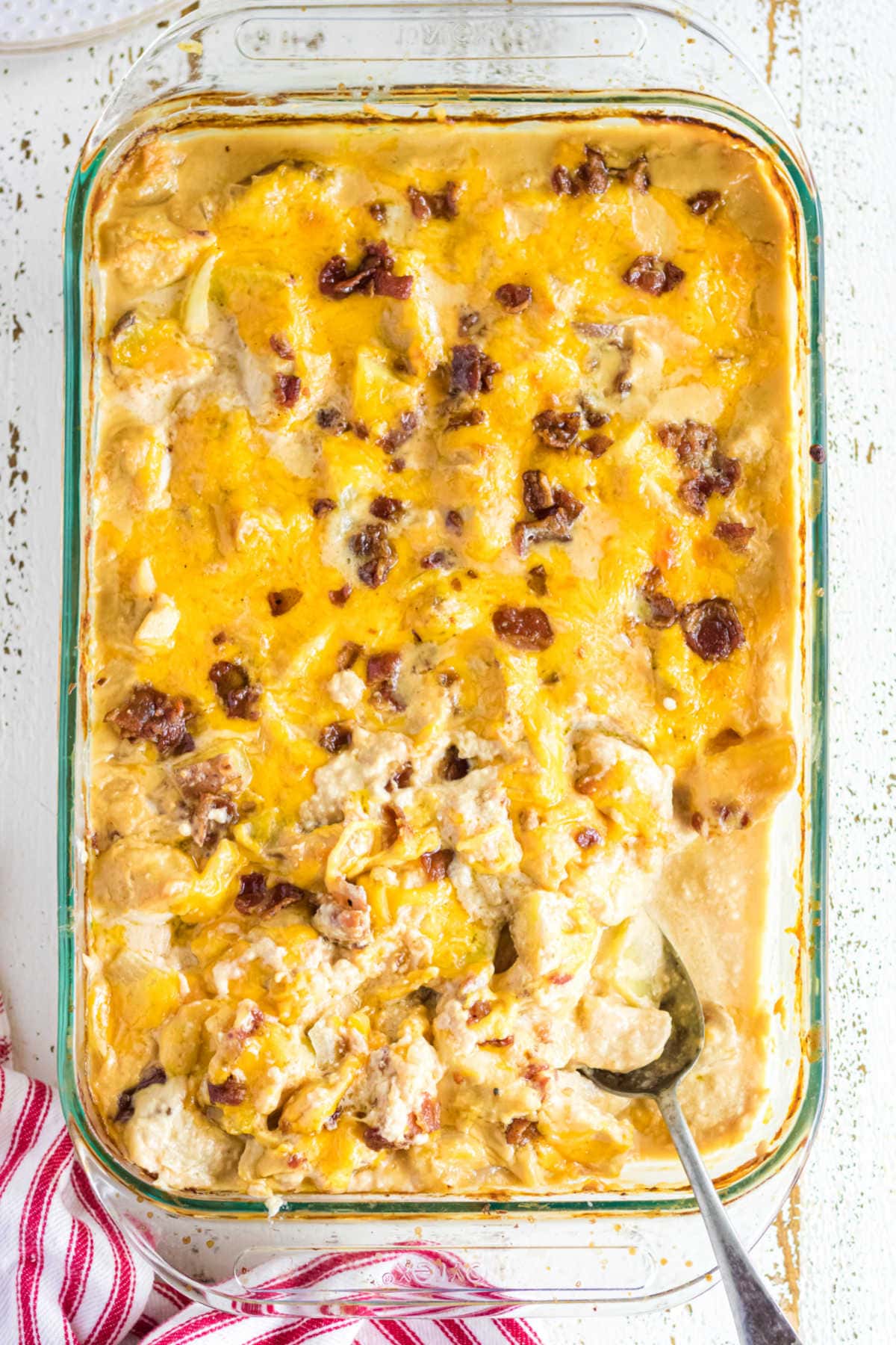 Overhead view of a casserole dish filled with chicken and potatoes in a cheese sauce.