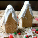 Closeup of two gingerbread houses ready to be decorated.