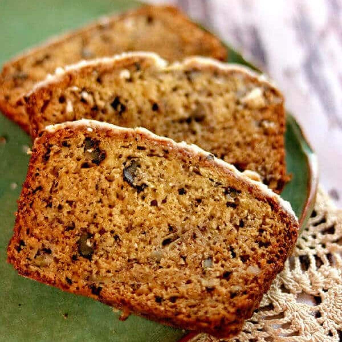 Closeup of sliced banana bread on a plate.