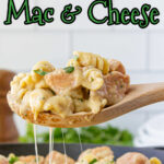 A serving of chicken mac & cheese being removed from the skillet with a text overlay for Pinterest.