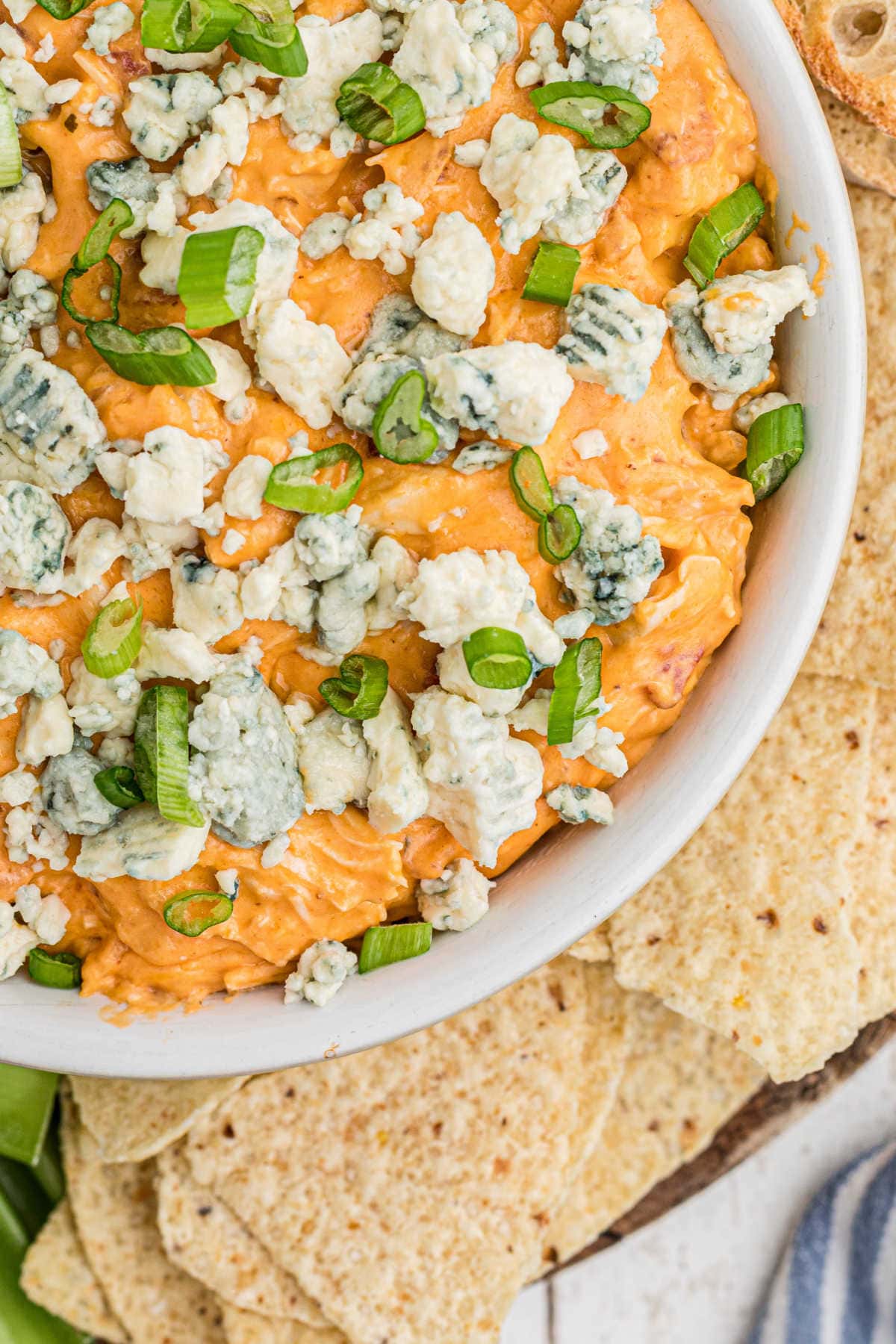 Overhead view of a bowl of dip with bleu cheese on tip.