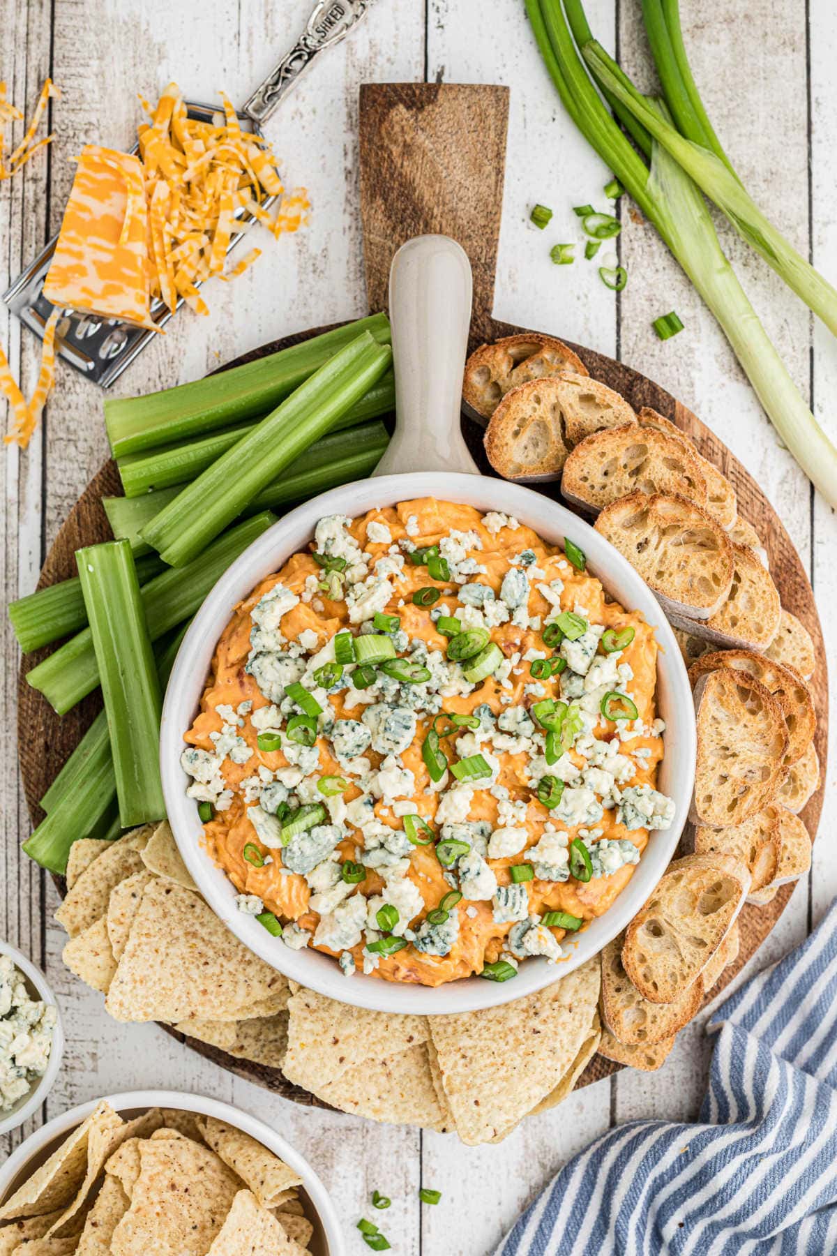 A snack board with dip in the center.