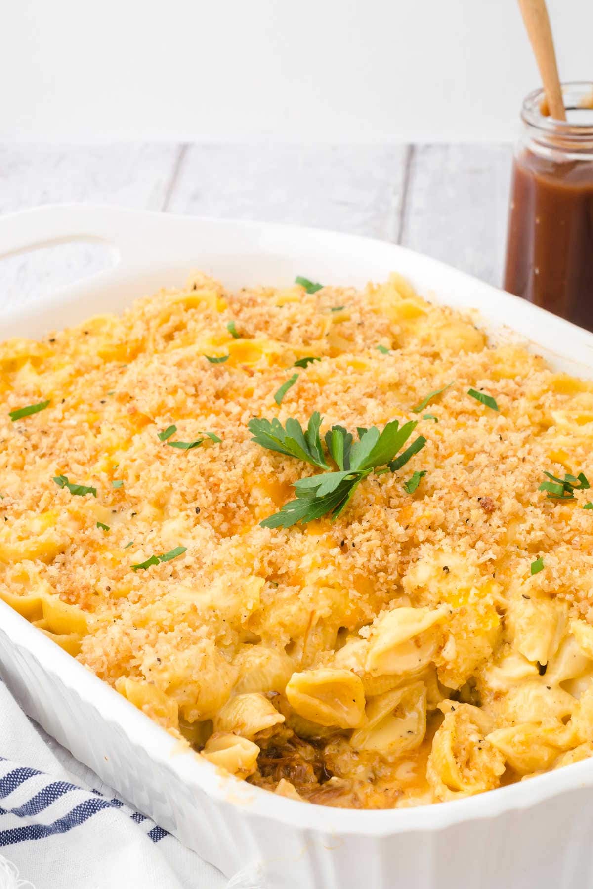 A closeup of a casserole dish full of pulled pork mac & cheese.