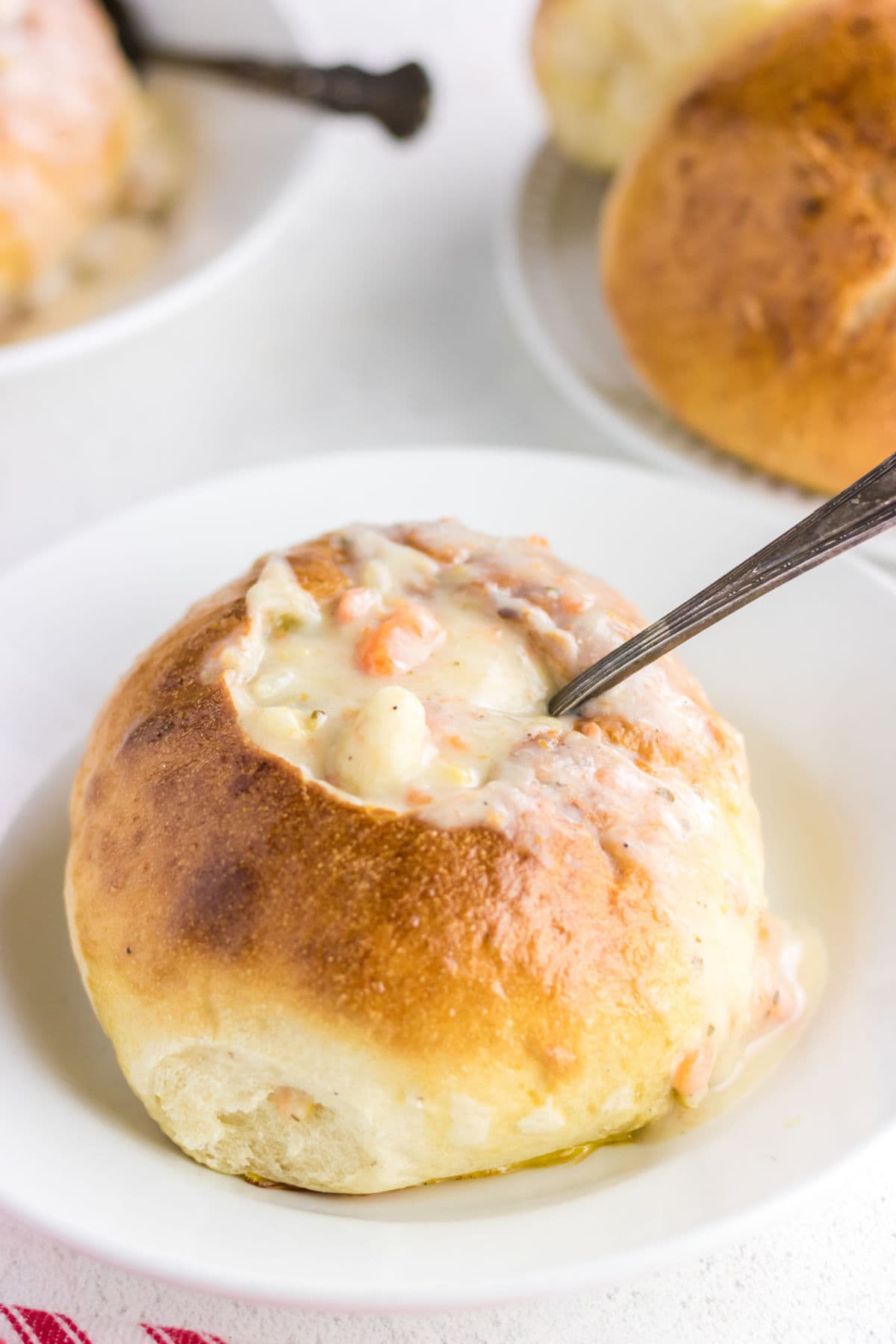 Closeup of finished bread with soup ladled inside.