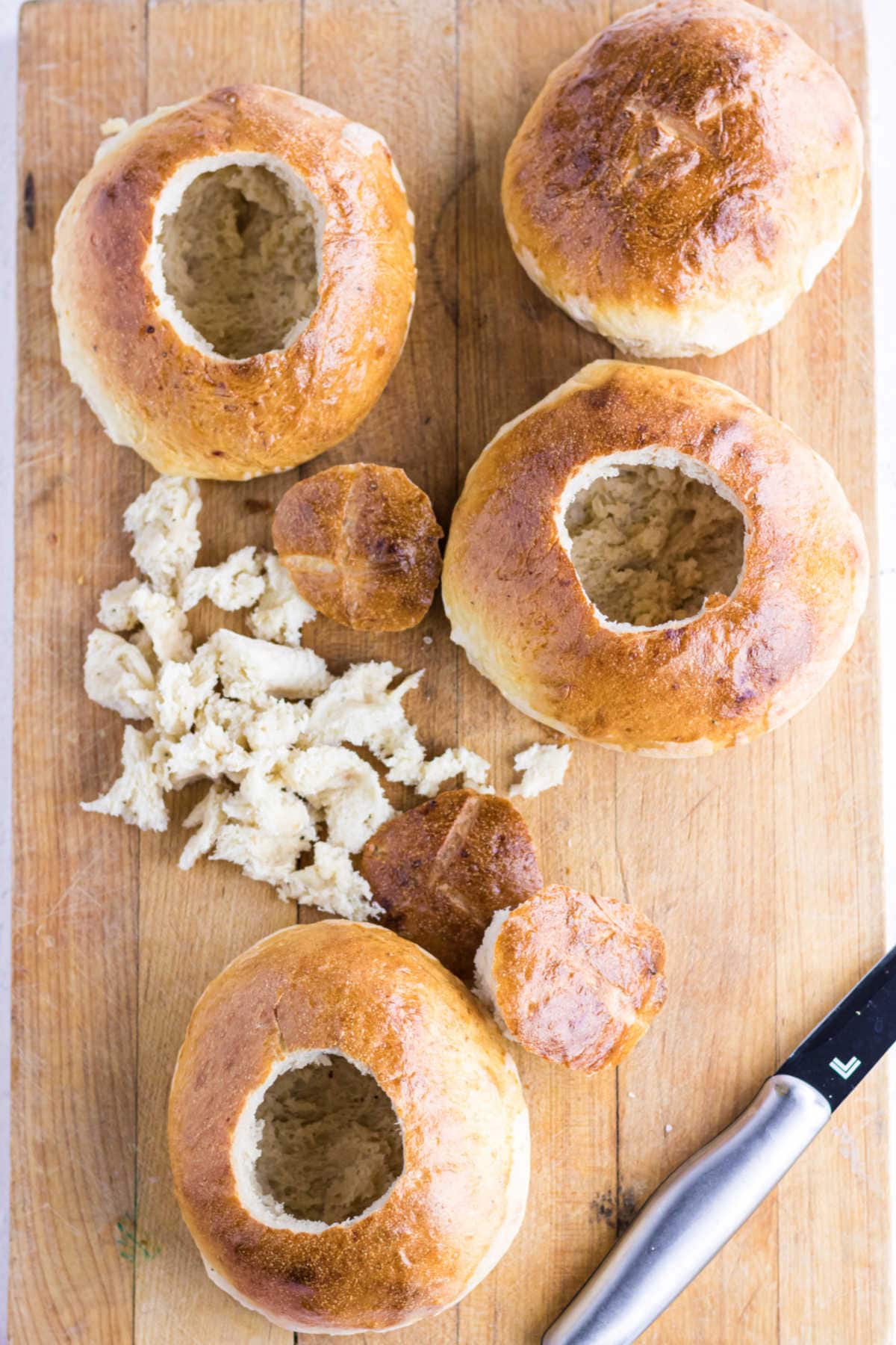 Bread rounds being hollowed out to hold soup.