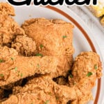 A plate with fried chicken on it and text overlay for Pinterest.