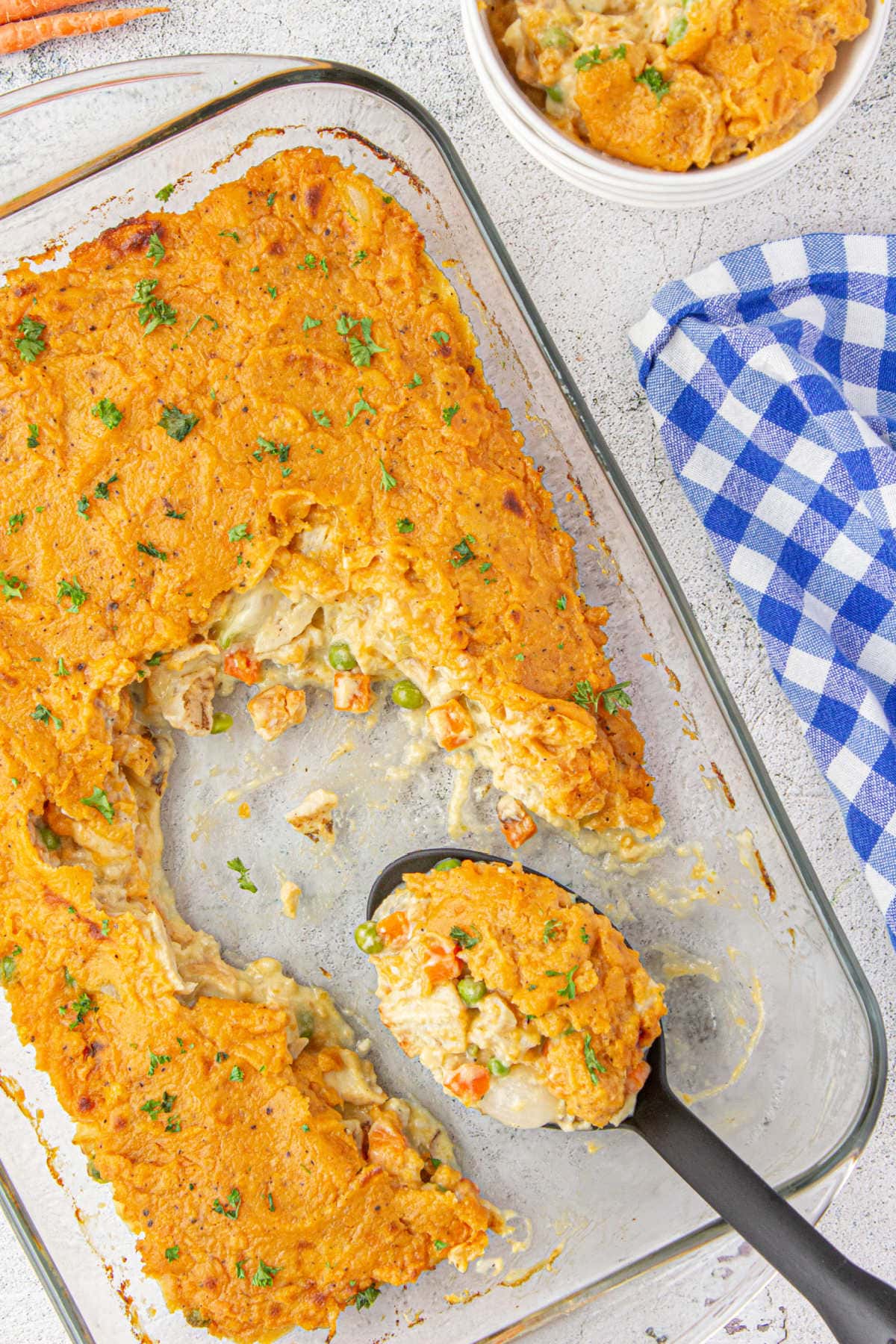 Overhead view of a casserole with a serving removed.