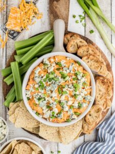 A snack board with dip in the center.