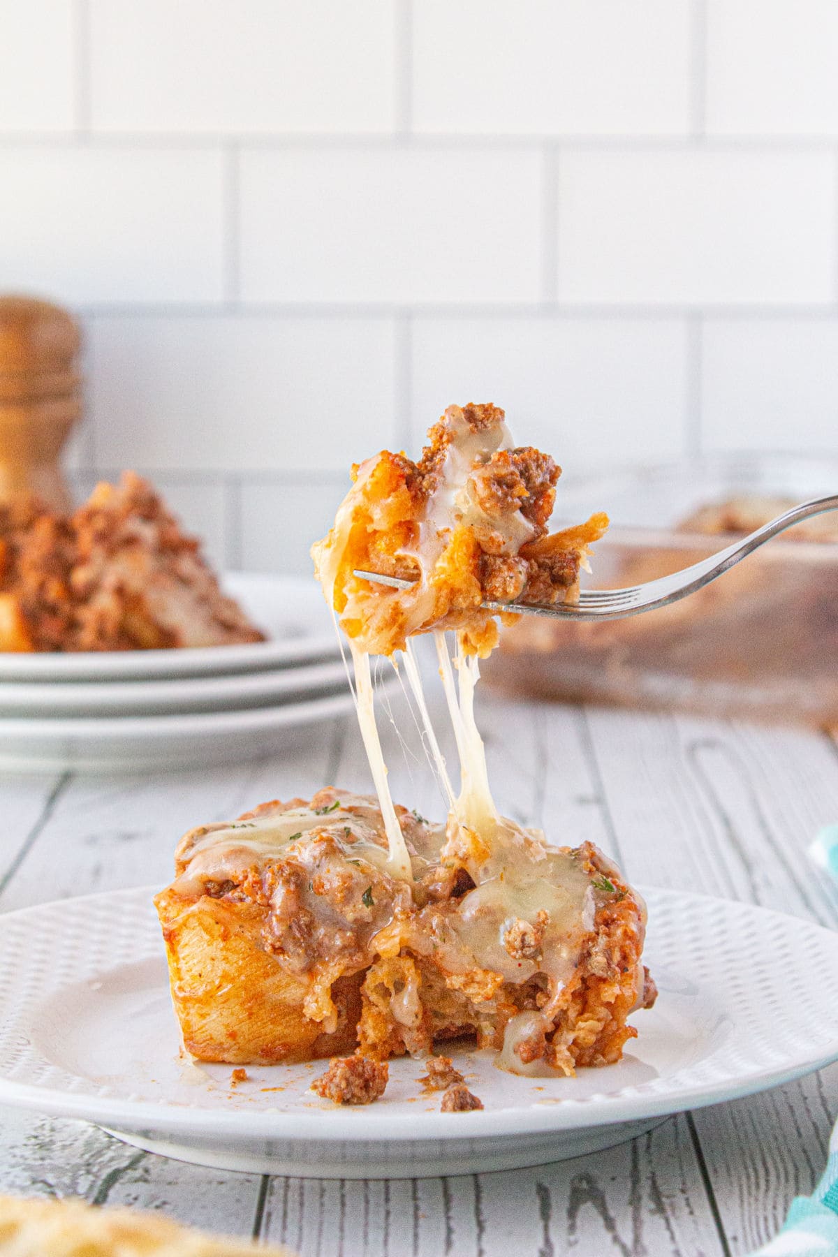 A serving of the casserole with a fork lifing a bite from the plate.