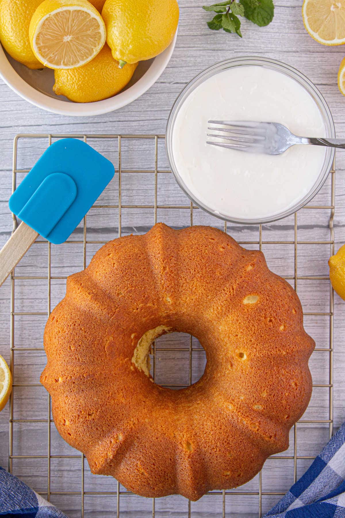 The baked cake being glazed.