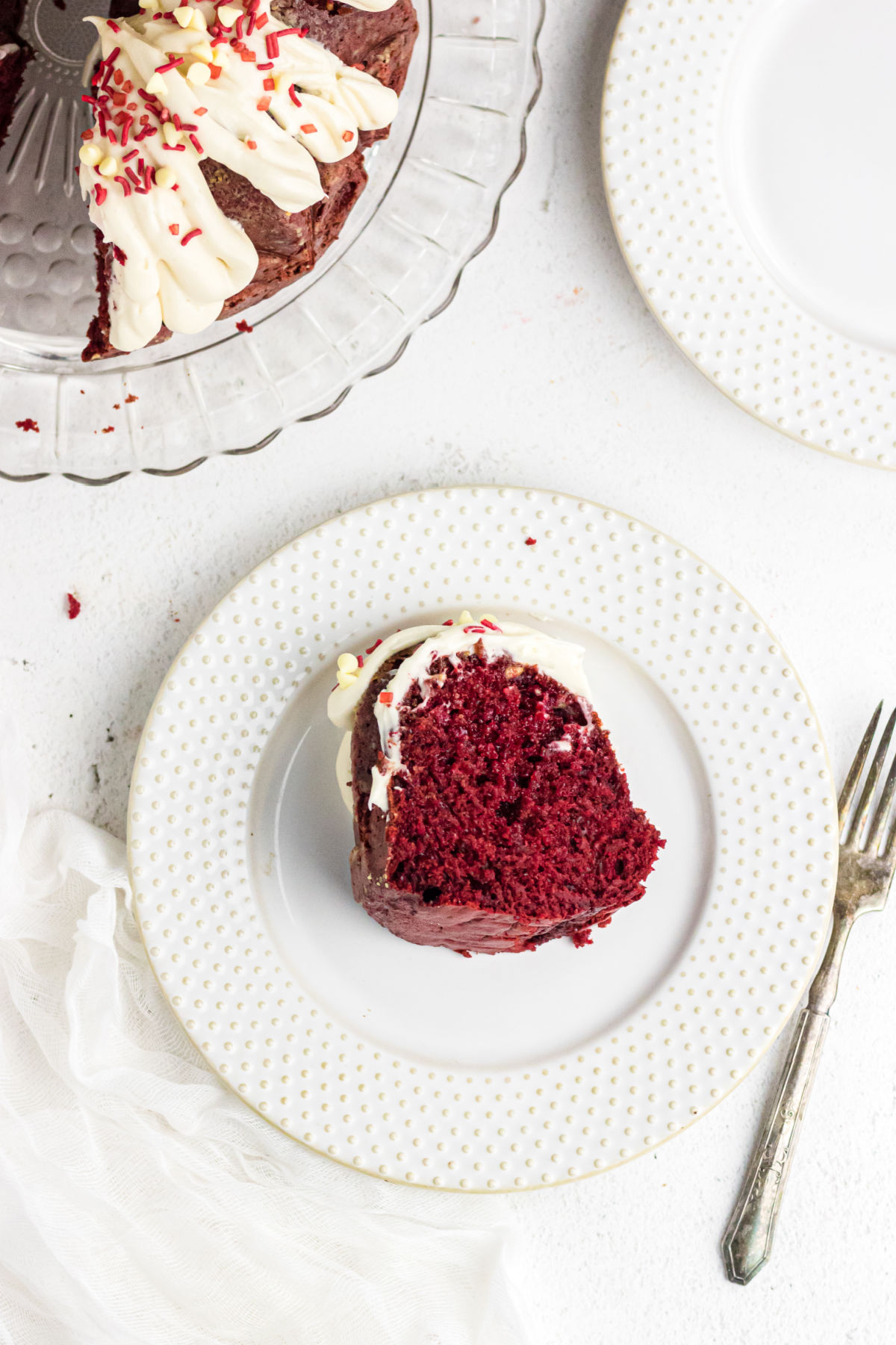 A slice of cake on a white plate.