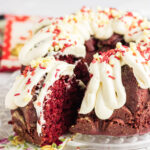 A slice being removed from the cake showing the inside texture and creamy frosting.