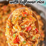 A serving spoon is filled with the finished tomato and rice mixture and there's a title text overlay for Pinterest.