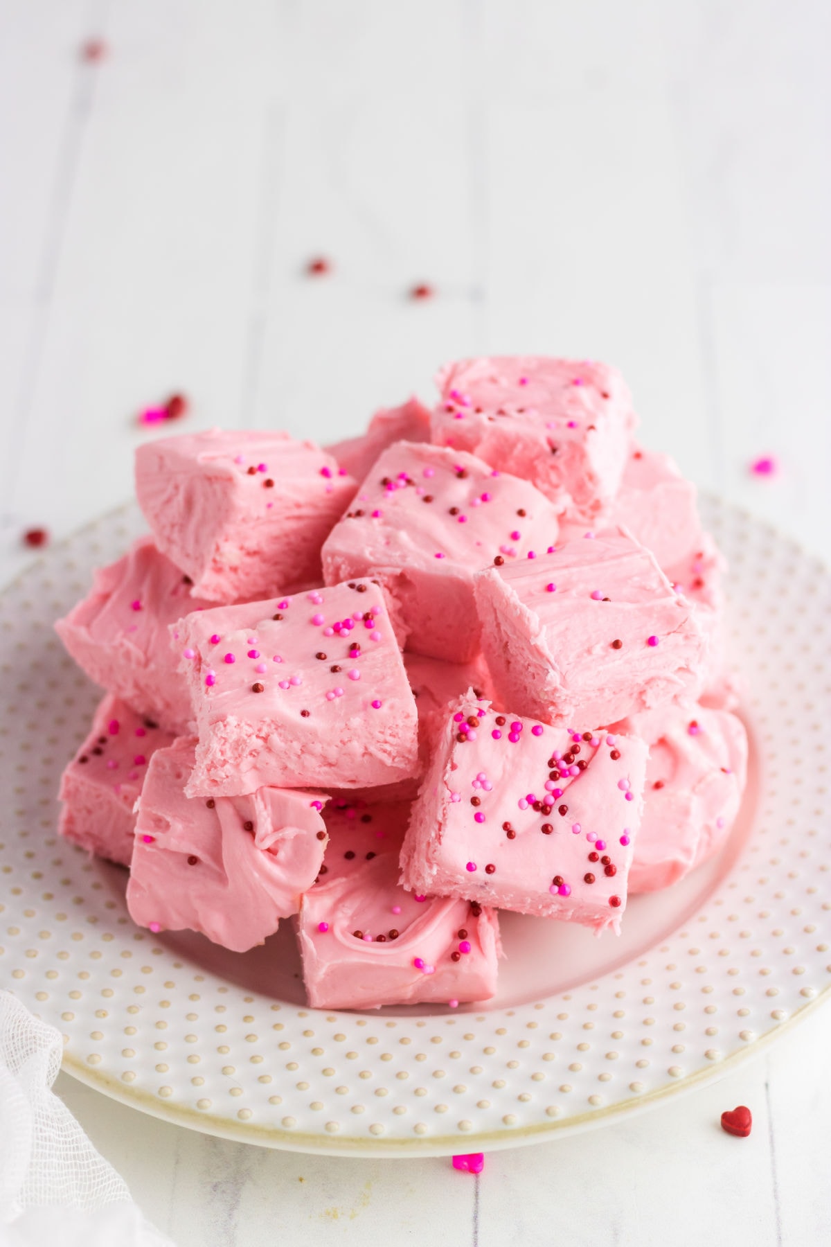 A plateful of strawberry fudge with sprinkles.