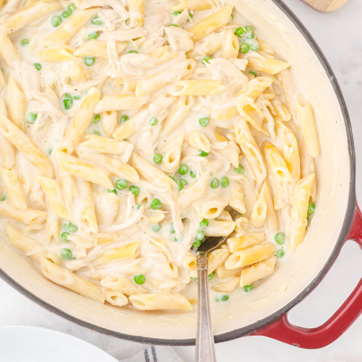 Closeup of this pasta dish in a pan with a serving spoon in it.