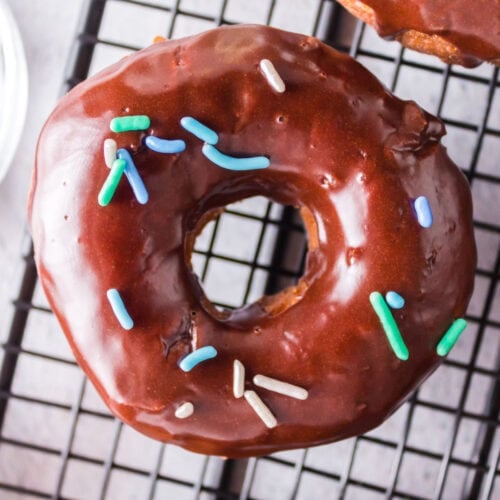 Closeup of a chocolate glazed donut with sprinkles.