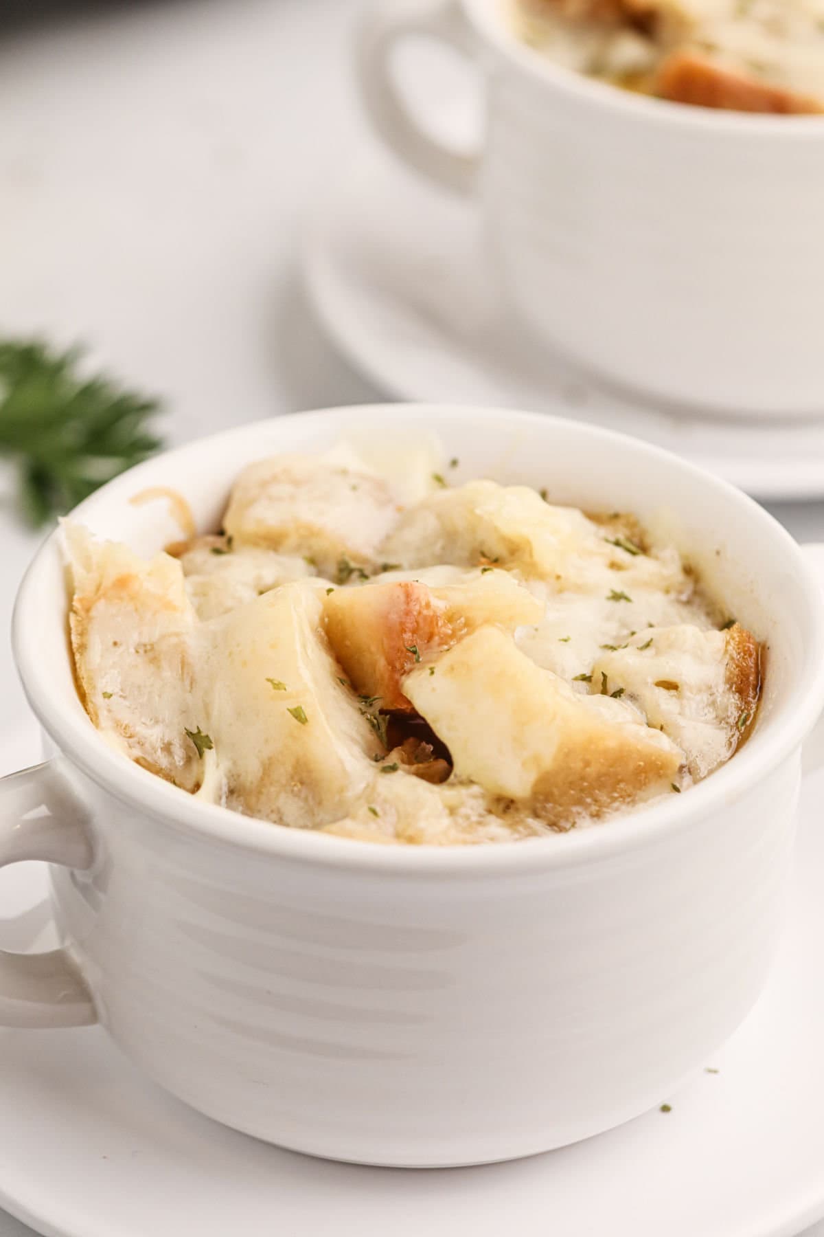 Closeup of the bread and melted cheese on top of the French onion soup.