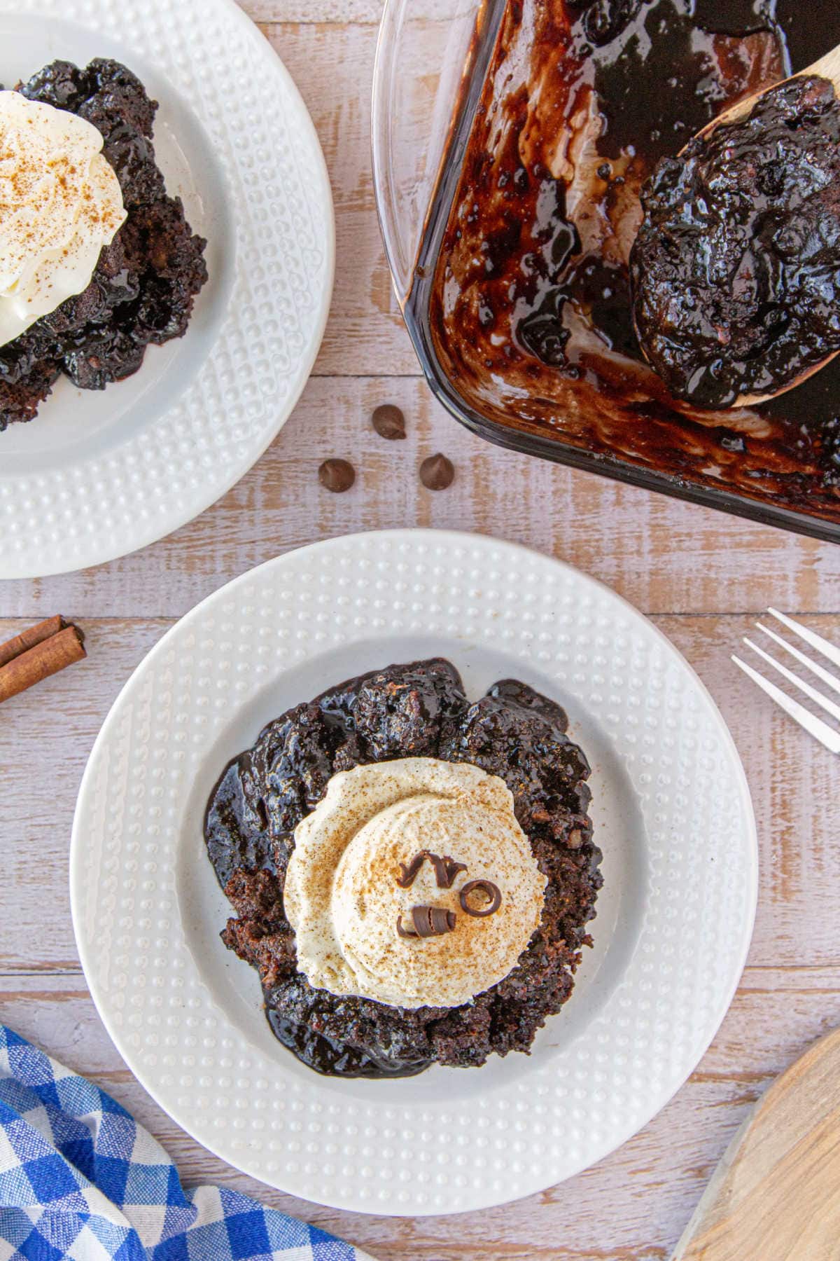 Overhead view of two dishes of chocolate cobbler with ice cream on top.