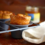 Closeup of popovers in a popover pan.