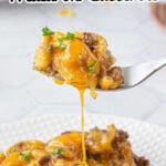 A fork lifting up a serving of cheeseburger macaroni casserole with a text overlay for Pinterest.