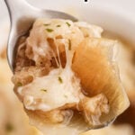 Closeup of a spoonful of soup with text overlay for Pinterest.