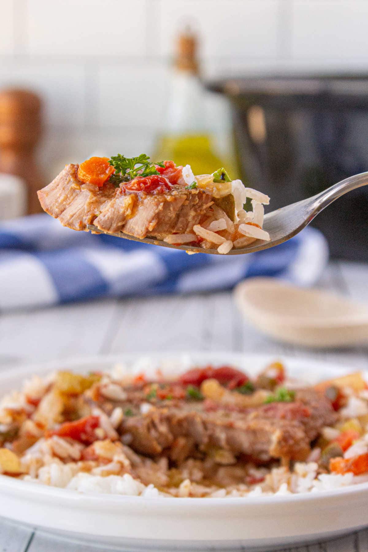 A bite of swiss steak on a fork.