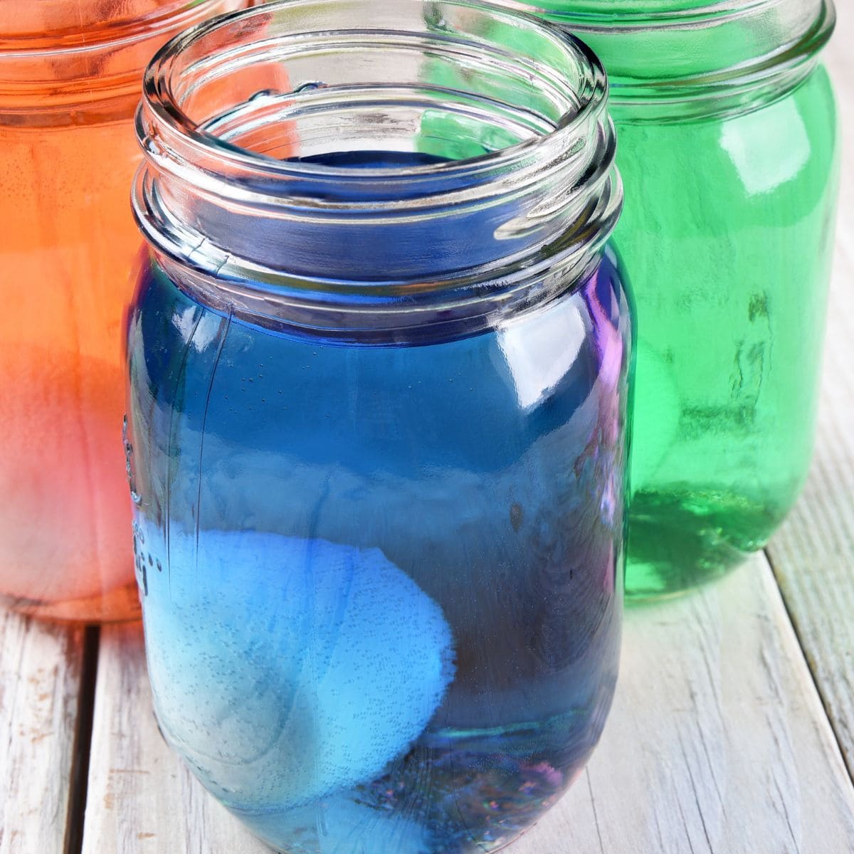 Mason jars with colored Koolaid in them.