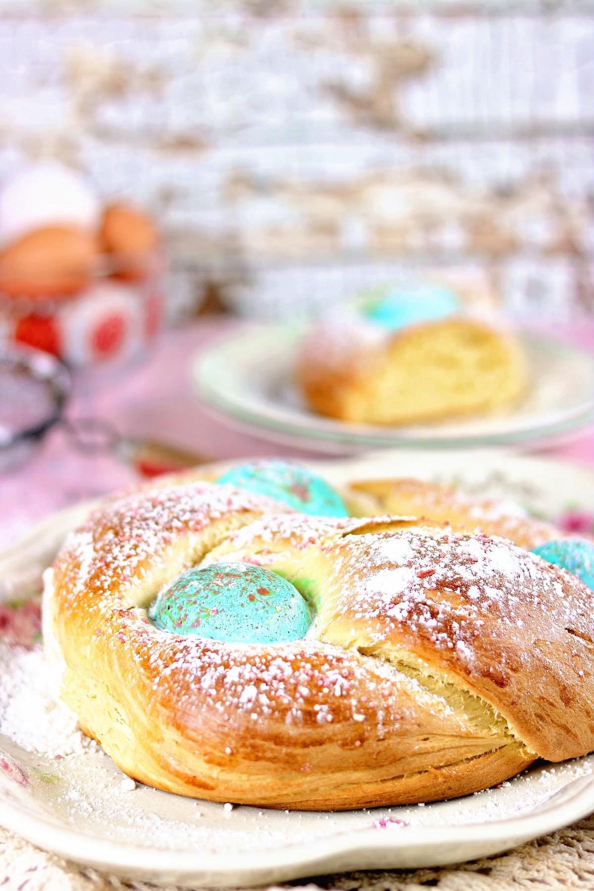 A round, braided loaf of bread with colored Easter eggs stuck between the strand of the braid.