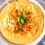 Overhead view of a finished bowl of jalapeno cheese grits with text overlay for Pinterest.