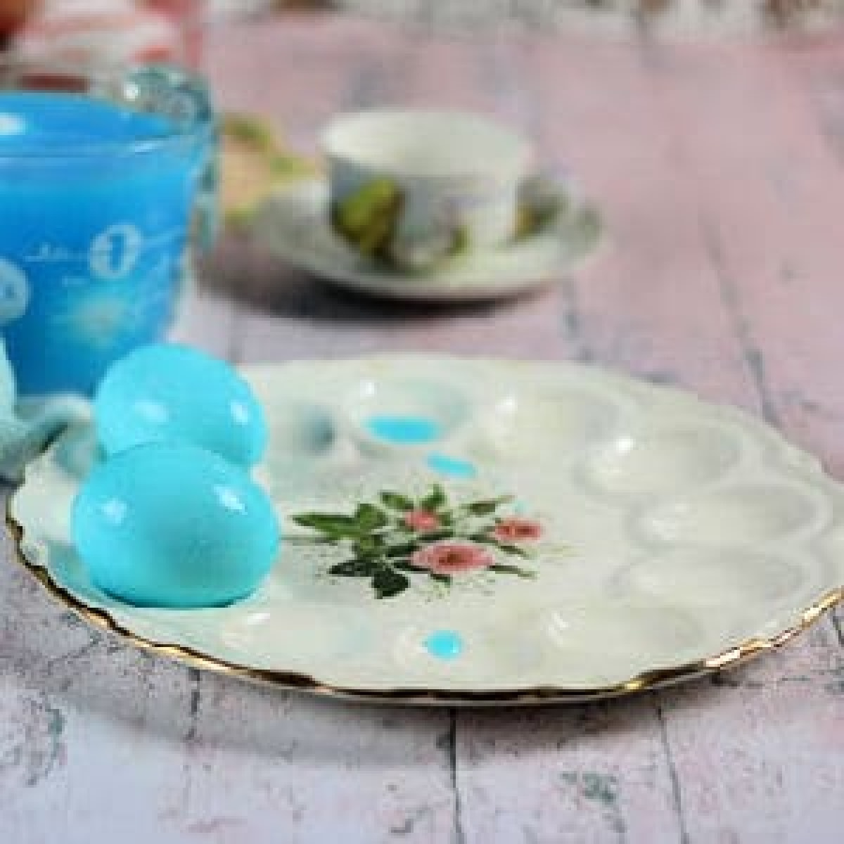 Blue dyed eggs drying on an egg plate.