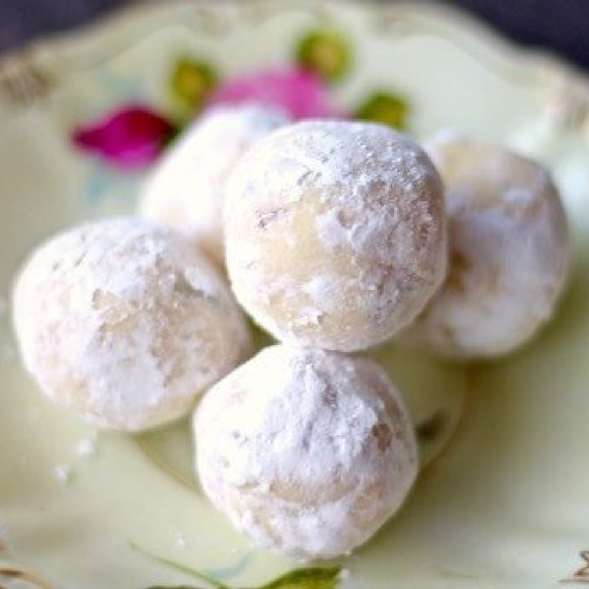 White chocolate truffles on a dessert plate.