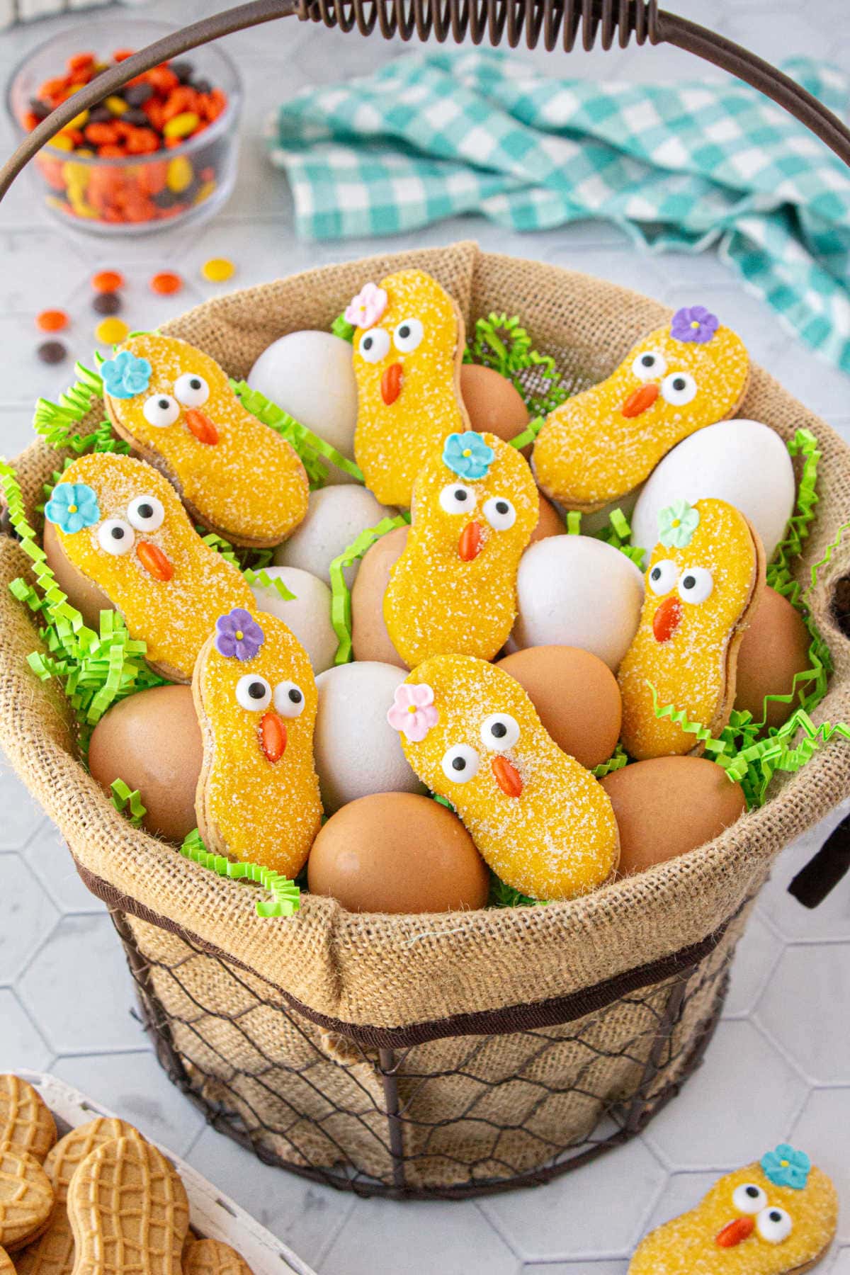 Easter basket filled with eggs and Nutter Butter Easter chicks cookies.