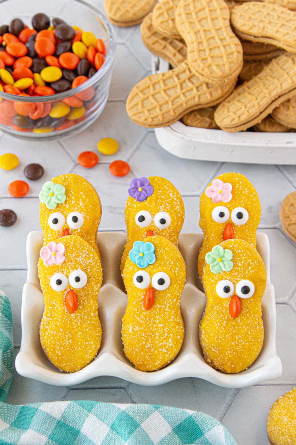 Decorated cookies drying in a white dish.