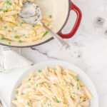 A bowl of creamy alfredo pasta with a text overlay for Pinterest.