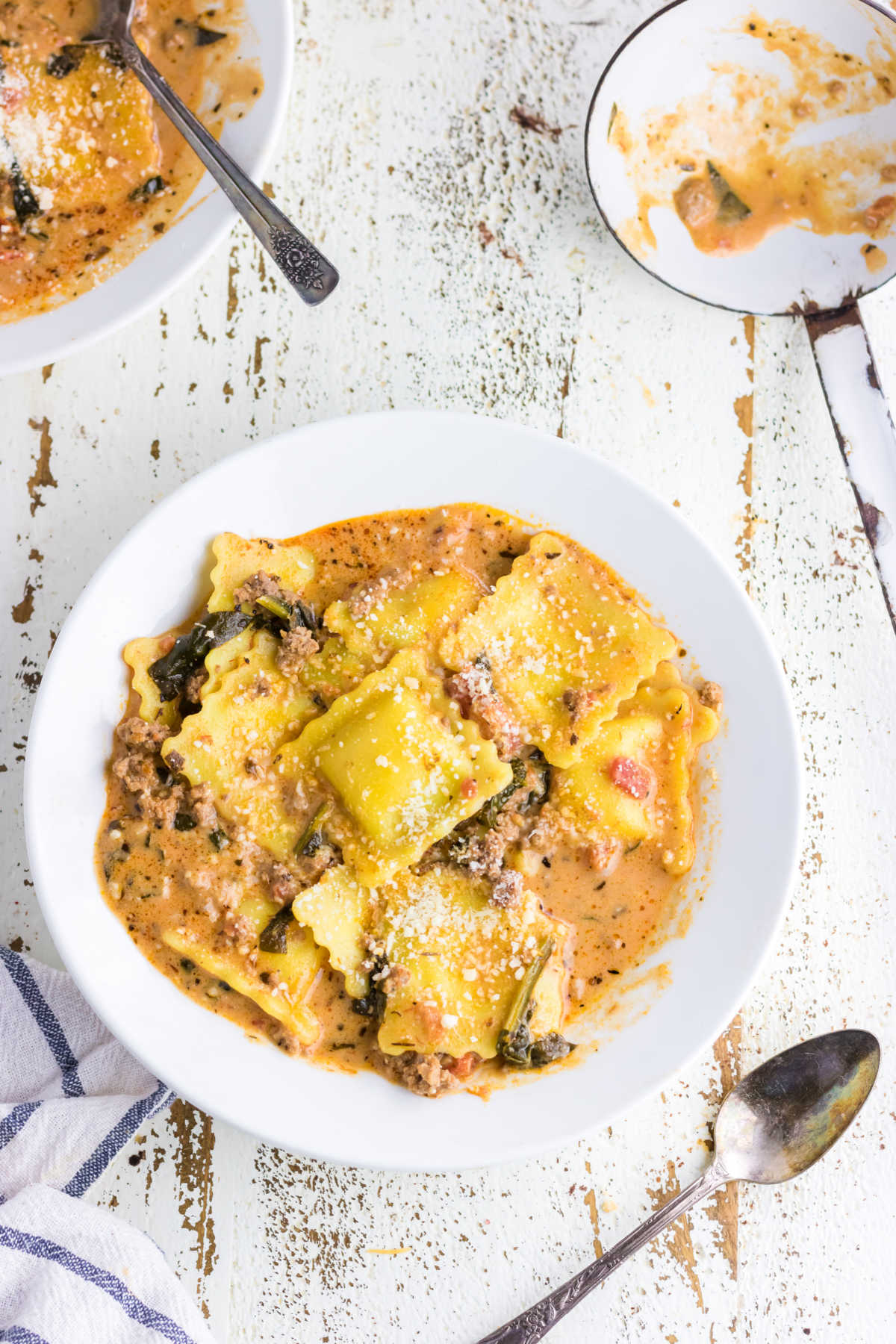 A bowl of ravioli soup on the table.