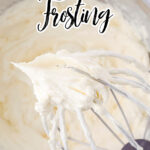 The whisk attachment to an electric mixer covered with white frosting and a text over lay for Pinterest.