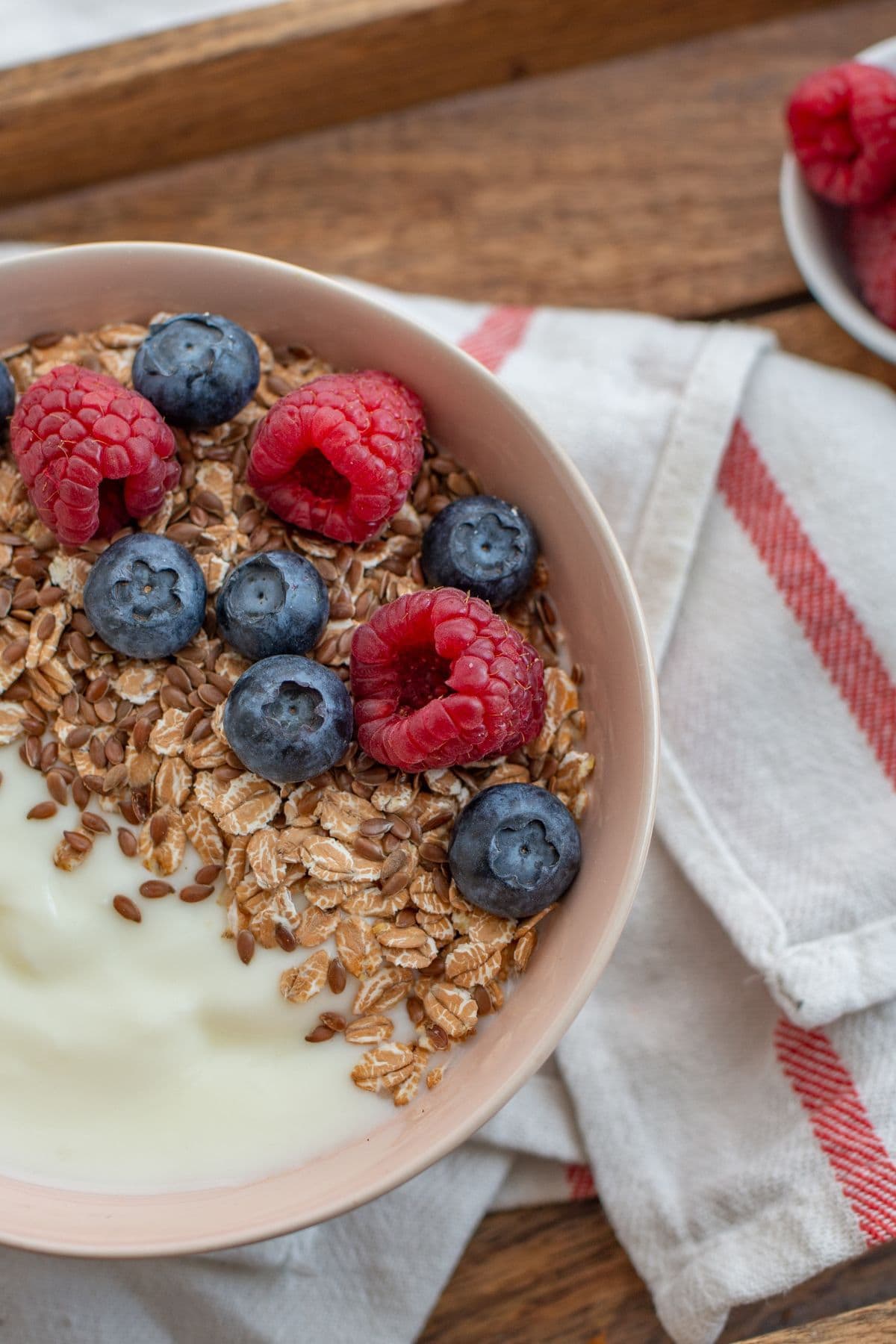 Overhead view of a bowl of yogurt and cereal.