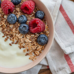 An overhead view of yogurt, fruit, and cereal for the feature image.