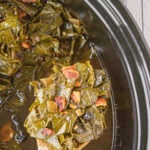 Greens in a slow cooker with a title text overlay for Pinterest.