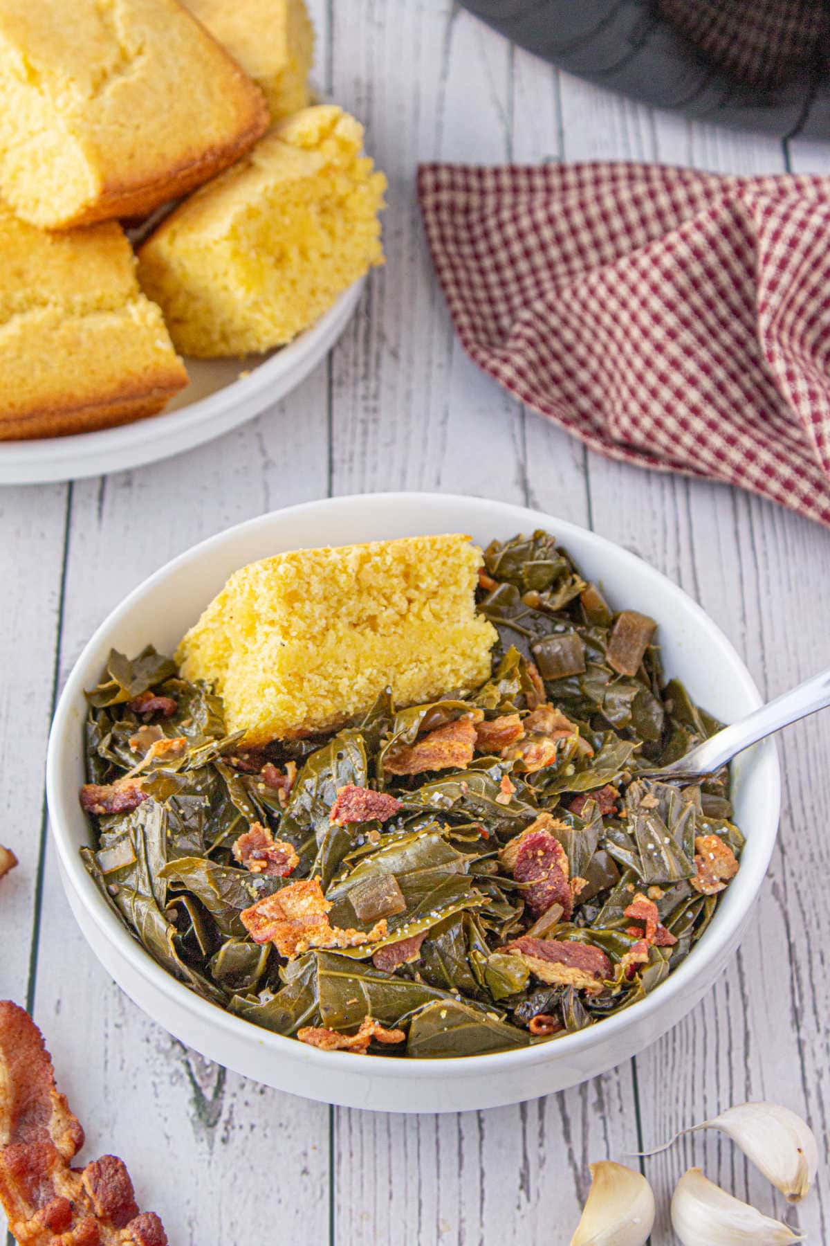 A bowl of greens with cornbread.