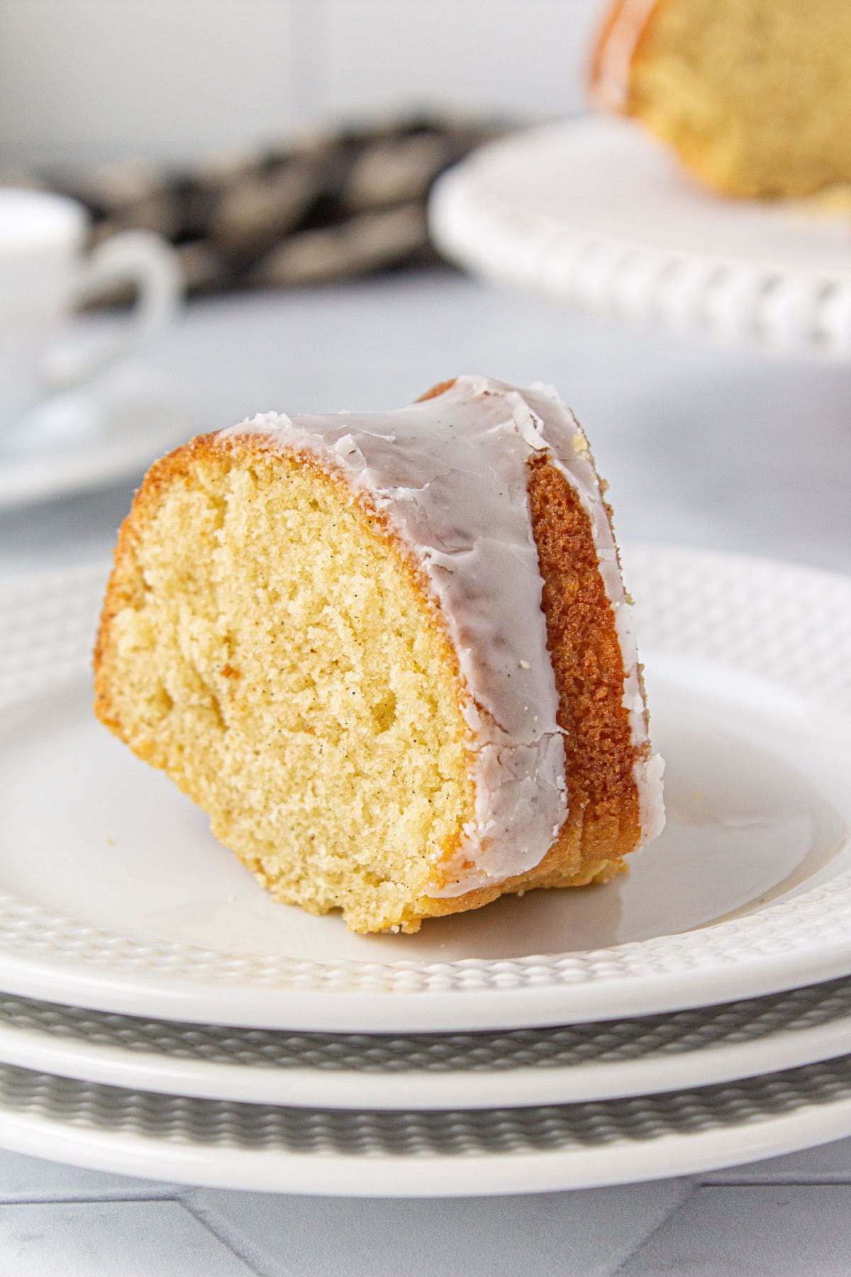 Slice of vanilla bundt cake on a plate.