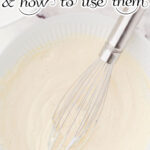 A whisk in t bowl of creamy white batter with text overlay for Pinterest.
